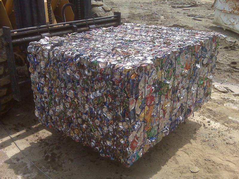 A large amount of aluminum cans are stacked on top of each other.