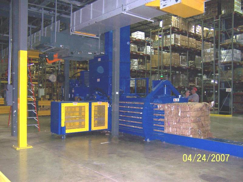 A warehouse with boxes and pallets on the floor.