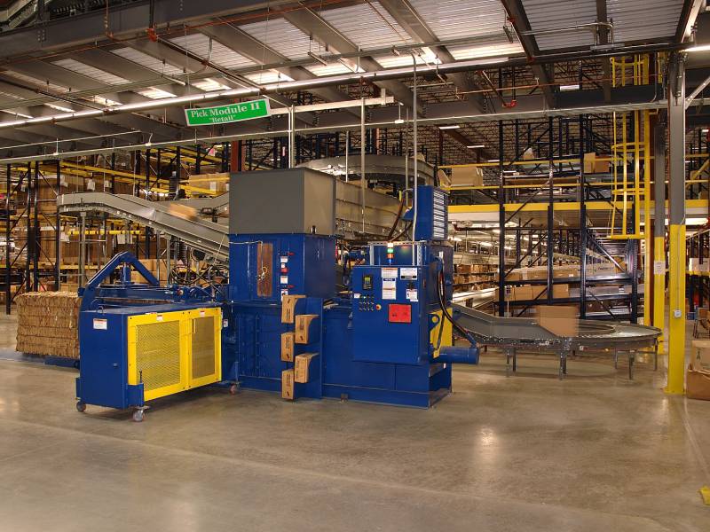 A warehouse with a large machine and lots of boxes.