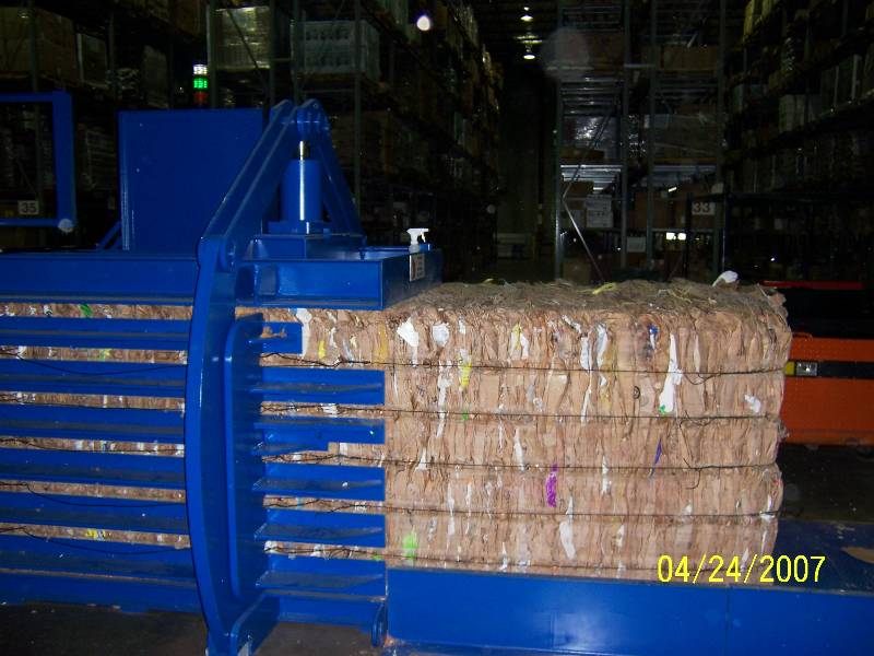 A large stack of cardboard boxes in a warehouse.