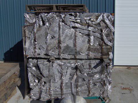 A pallet of aluminum foil sitting in front of a building.
