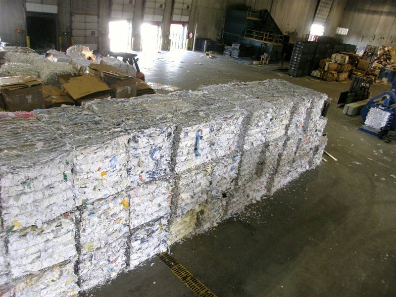 A large pile of paper in an industrial setting.