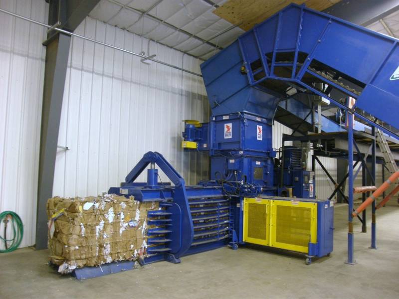 A large blue machine with many boxes in it.
