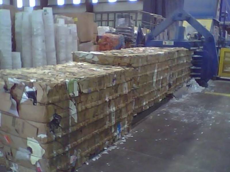 A large amount of cardboard is stacked on top of each other.
