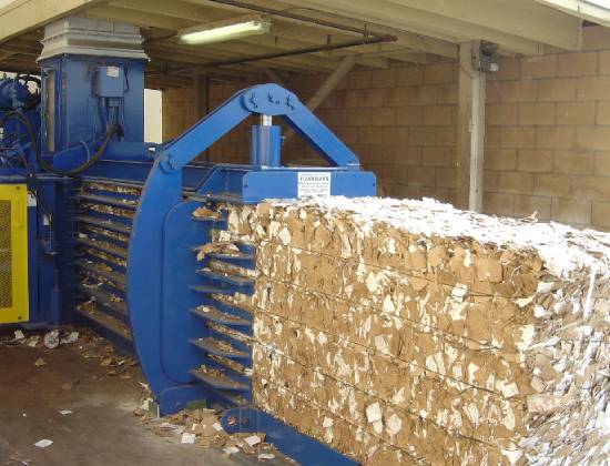 A large machine that is making paper in the warehouse.