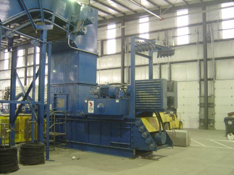 A large machine in an industrial setting with windows.