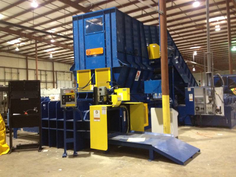 A large blue and yellow machine in a warehouse.