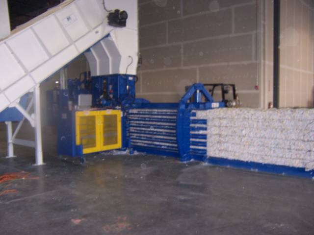 A blue and white machine is in the middle of a room.