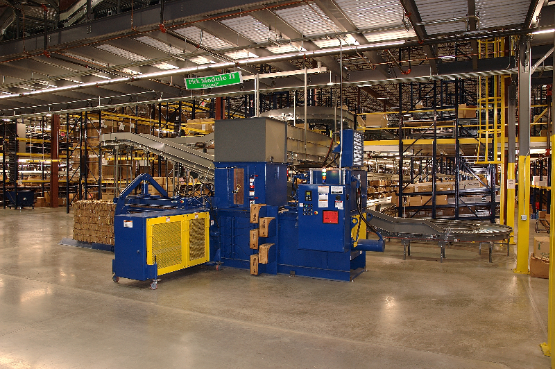 A warehouse with many boxes and a conveyer belt.