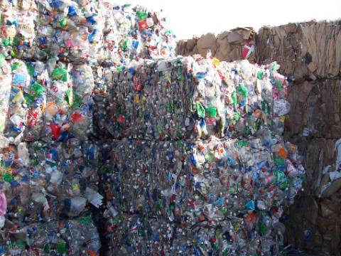 A pile of plastic bottles and cans stacked on top of each other.