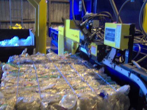 A machine that is cutting plastic bags.
