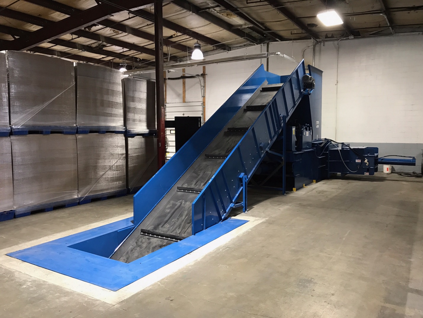 A blue conveyor belt in an industrial setting.