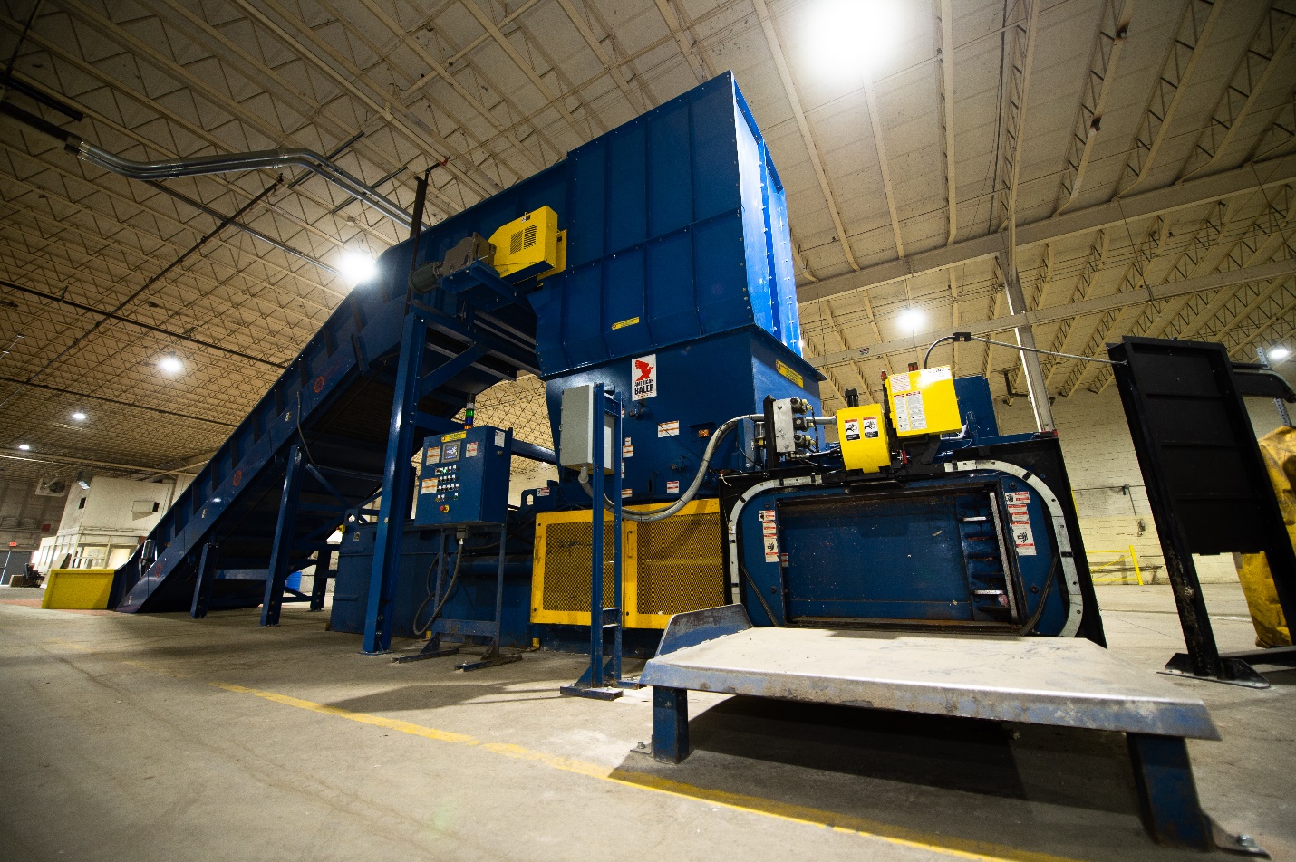 A large blue machine in a warehouse.