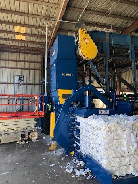 A large machine that is in the warehouse.