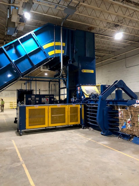 A large blue and yellow machine in a warehouse.